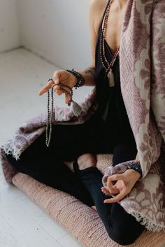 a woman sitting on the floor with her hands out