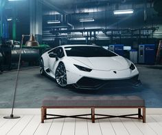 a white sports car parked in a garage