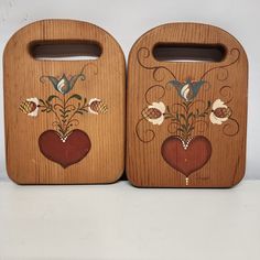 two wooden boxes with painted designs on them