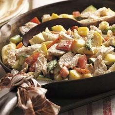 a pan filled with pasta and vegetables on top of a table