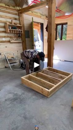 a man is working on some wood in a room that has been made into a house