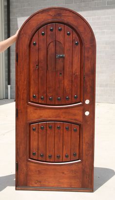 a person standing in front of a wooden door