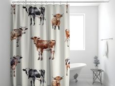 a shower curtain with cows on it in a bathroom