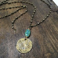 "Antiqued brass Burmese \"Harvest\" coin representing abundance paired with a tuquoise colored ceramic bead.  Hangs on a fully adjustable brass chain that clasps anywhere along the chain for full flexibility. The chain can also be worn alone as a single chain, is long enough to be worn doubled up or wrapped as a bracelet.  Total length is 40\"" Brass Coin Jewelry With Adjustable Chain, Bohemian Coin Pendant Jewelry For Meditation, Nickel Free Brass Coin Pendant Necklace, Nickel-free Brass Coin Pendant Necklace, Spiritual Brass Coin Jewelry, Turquoise Brass Spiritual Jewelry, Turquoise Nickel-free Brass Jewelry, Bohemian Adjustable Patina Necklace, Handmade Brass Coin Necklace With Round Pendant