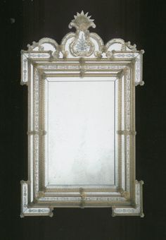 an ornate mirror is hanging on the wall