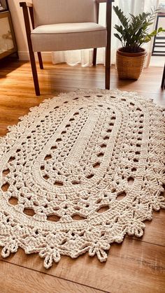 a crocheted rug on the floor with a chair in the background