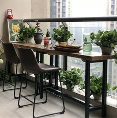 a balcony with plants and potted plants on the railing, along with two bar stools