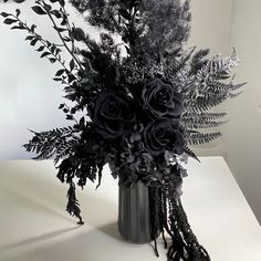 a black and white photo of flowers in a vase