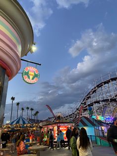 people walking around an amusement park at dusk