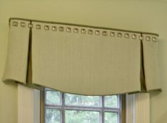 a window with a valance that has beading on it