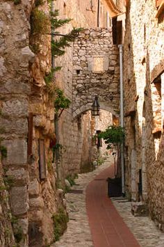 an alley way with stone buildings and cobblestones