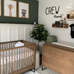 a baby's room with two cribs and some pictures on the wall