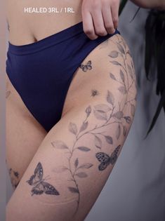 a woman with butterfly tattoos on her legs and thighs, showing off her butts