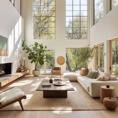 a large living room with high ceilings and lots of windows on the wall to let in natural light