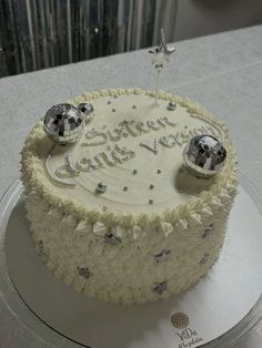 a white cake with silver decorations on it