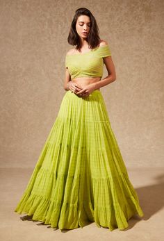 Editor's Note This ensemble features a green tiered skirt made of flowy fabric and paired with a tulle embroidered off-shoulder top. The skirt has multiple layers, giving it a voluminous and dr... Lime Green Skirt, Georgette Skirt, Fabric Skirt, Green Lehenga, Flowy Fabric, Intricate Embroidery, Tulle Fabric, Green Blouse, Tier Skirt