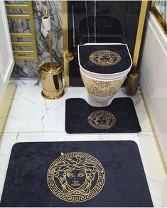 two bathroom rugs with gold lion heads on them