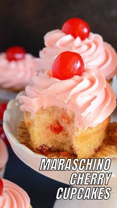 cupcakes with pink frosting and cherries on top