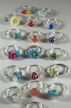 a collection of rings with different colors and designs on them, all in various sizes