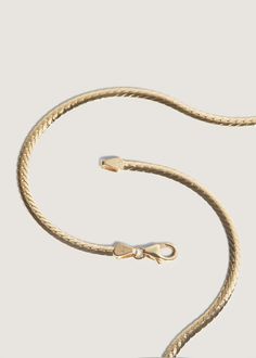 Elegant and sophisticated, herringbone chains date back to Ancient Egypt. They're often referred to as liquid gold, and will elevate any look. Looking for something slightly bolder? Shop our Kennedy Herringbone Chain II. Complete the look with the Carter Flat Herringbone Chain II. This is the thinner version of the Kennedy Herringbone Chain II.Features a lobster clasp for secure closure.Herringbone Care: Please note that herringbone chains require careful handling. We recommend storing them on a Elegant Formal Herringbone Chain Necklace, Elegant Formal Herringbone Necklace, Classic Gold Herringbone Necklace With Snake Chain, Classic Herringbone Necklace With Box Chain For Formal Occasions, Classic Yellow Gold Snake Chain Necklace, Classic Gold Snake Chain Necklace, Classic 14k Gold Snake Chain Necklace, Gold Classic Herringbone Link Necklace, Classic Gold Link Herringbone Necklace