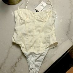 Never Worn, New With Tag Zara Bodysuit. With Size Zipper. Size M Chic White High Waist Bodysuit, White High-waist Bodysuit For Night Out, Chic High Waist White Bodysuit, White High Waist Bodysuit For Night Out, White Bodysuit For Summer Night Out, Elegant Cream Swimwear For Spring, Elegant High-waist Summer Bodysuit, Elegant High Waist Summer Bodysuit, White Summer Party Bodysuit