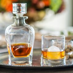 two glasses and a decanter on a tray