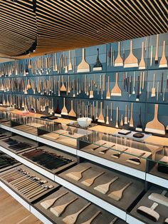 a room filled with lots of different types of pottery on shelves next to each other