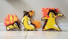 three pixelated pokemons sitting next to each other on the floor in front of a wall