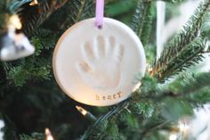 an ornament hanging from a christmas tree with the words diy handprint ornaments on it