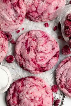 raspberry cookies with powdered sugar on top and spoons next to them