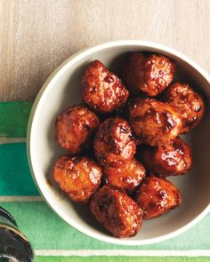 a white bowl filled with meatballs on top of a table