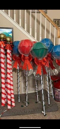 some candy canes wrapped in red, white and blue paper with bows on them