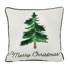 a white pillow with a green christmas tree on it