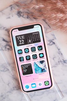 a pink phone sitting on top of a marble counter