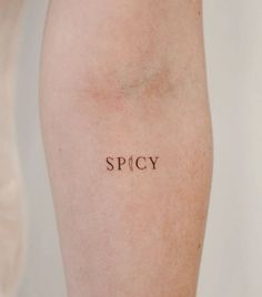 the word spicy written on someone's leg