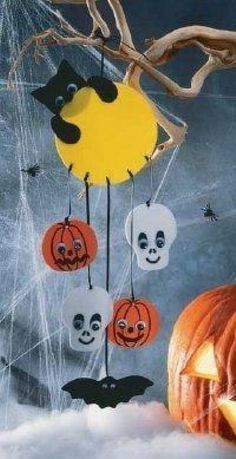 a halloween scene with pumpkins and bats hanging from the strings in front of a spooky tree