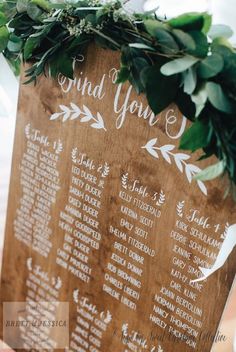 a wooden table plan with greenery on it