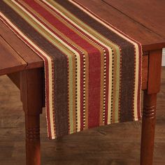 a wooden table topped with a striped table runner