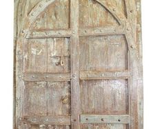 an old wooden door with two arched doors