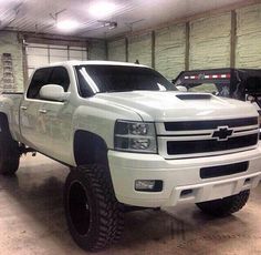 a large white truck parked in a garage