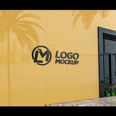 the entrance to a building with palm trees in front of it and a logo mockup on the wall