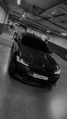 a black car parked in a parking garage