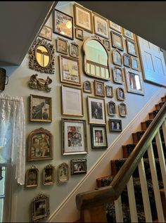 a staircase with many framed pictures on the wall