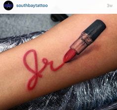 a woman's arm with a red lipstick and the word love written on it