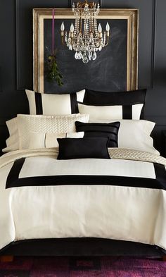 black and white bedding in a bedroom with chandelier