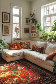 a living room filled with lots of furniture and plants on top of a large rug