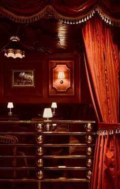 an ornately decorated room with red curtains