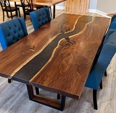 a large wooden table with blue chairs around it