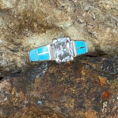 This beautiful Sterling Silver Ring, as part of the Arizona Blue collection features Kingman Turquoise with Cubic Zirconia. Ring Width: 3/8"; Shank Width: 1/8" The ring is designed by David Rosales, one of the finest contemporary Southwest Artists in the world. He is the founder and co-owner of Supersmiths, Inc. of Gallup, NM. Each ring is custom made and carries a lifetime guarantee. .