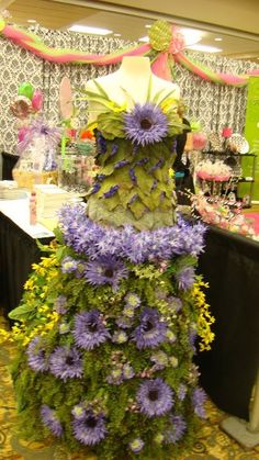 a dress made out of flowers sitting on top of a table